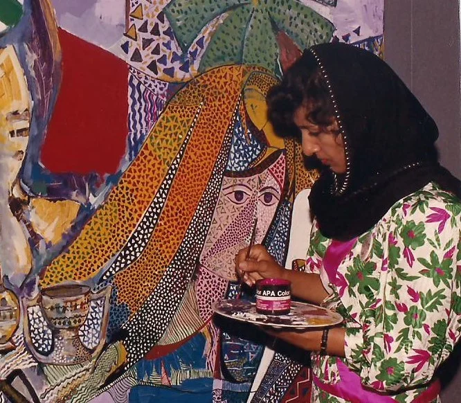 Dr. Najat Makki during her active painting phase in the 1980s, when she was experimenting heavily with mixed media, tempera/acrylic ("APA Color" jars as seen in her hand), and rich geometric patterns overlaid on figures.