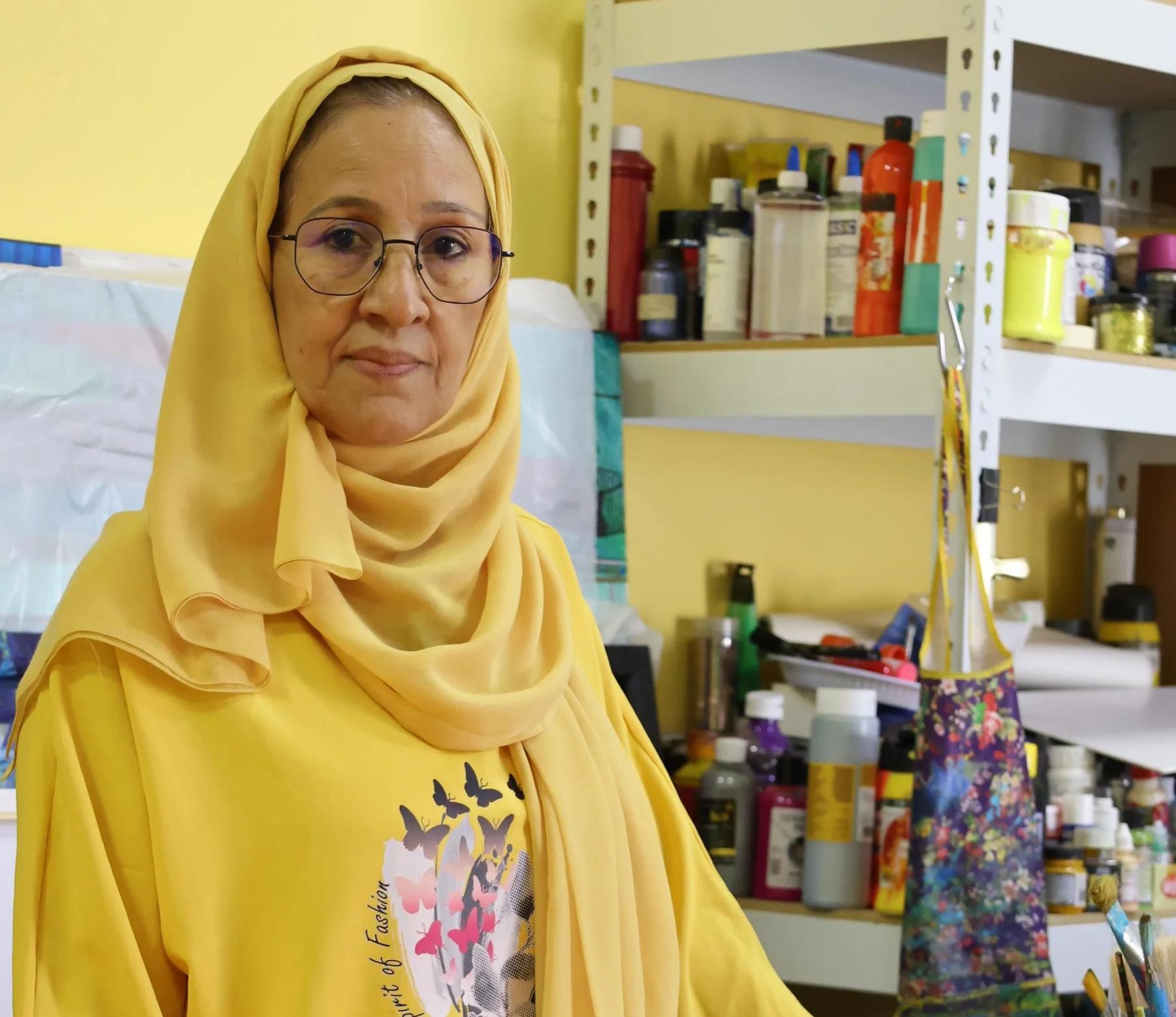 Dr. Najat Makki in her studio surrounded by her pigments, tools, and ongoing works. Photo courtesy of the artist.